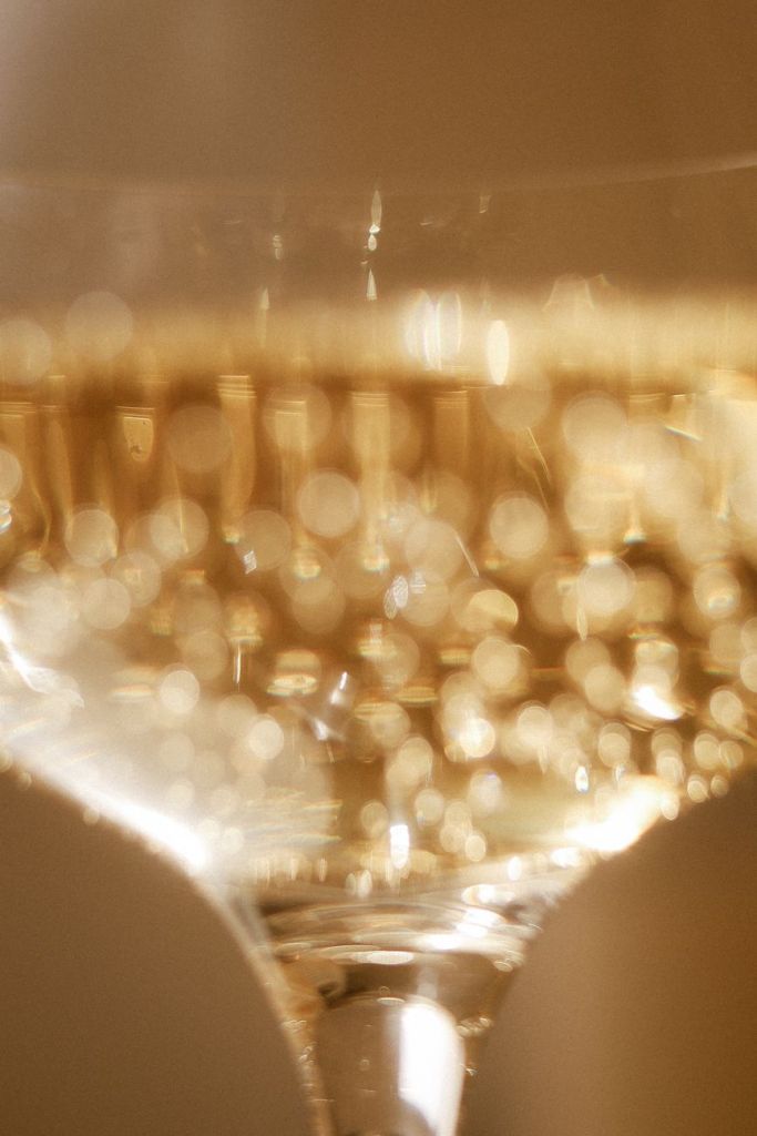 Close-up of bubbles rising in a glass of sparkling wine